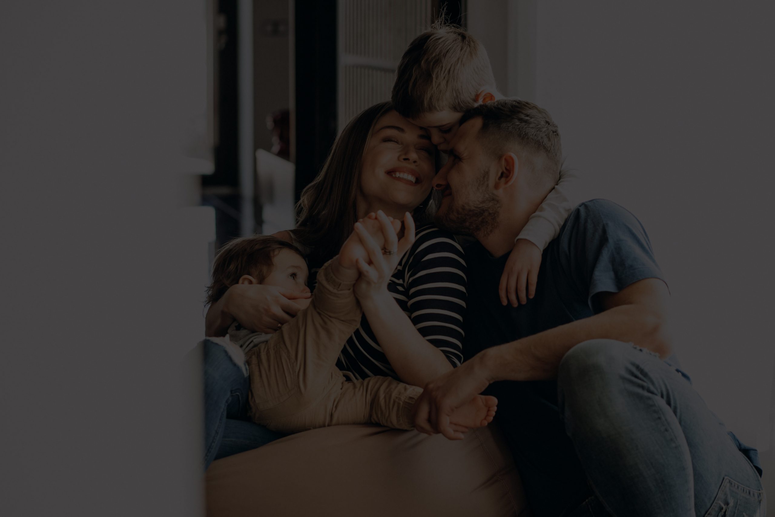 Young family with their sons at home having fun